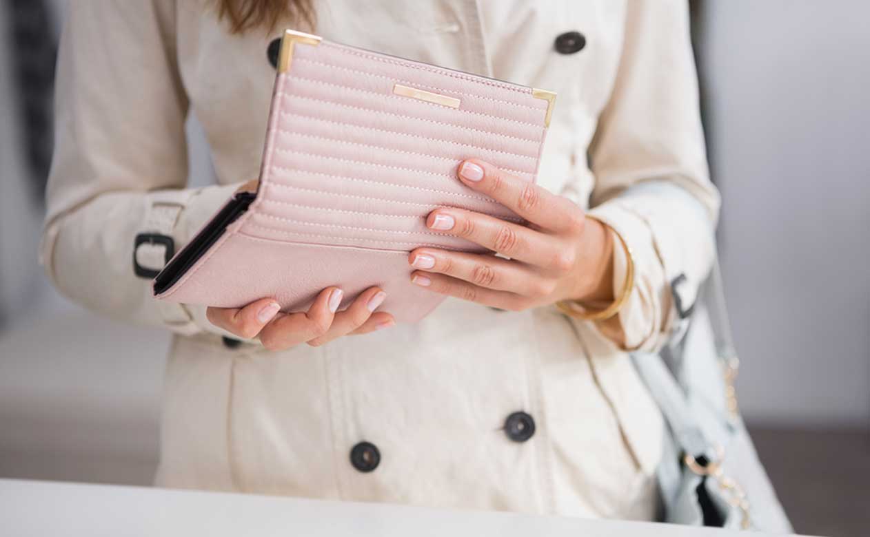 Woman opening wallet.